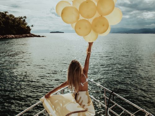 Stock Image Woman Holding Balloons on Boat